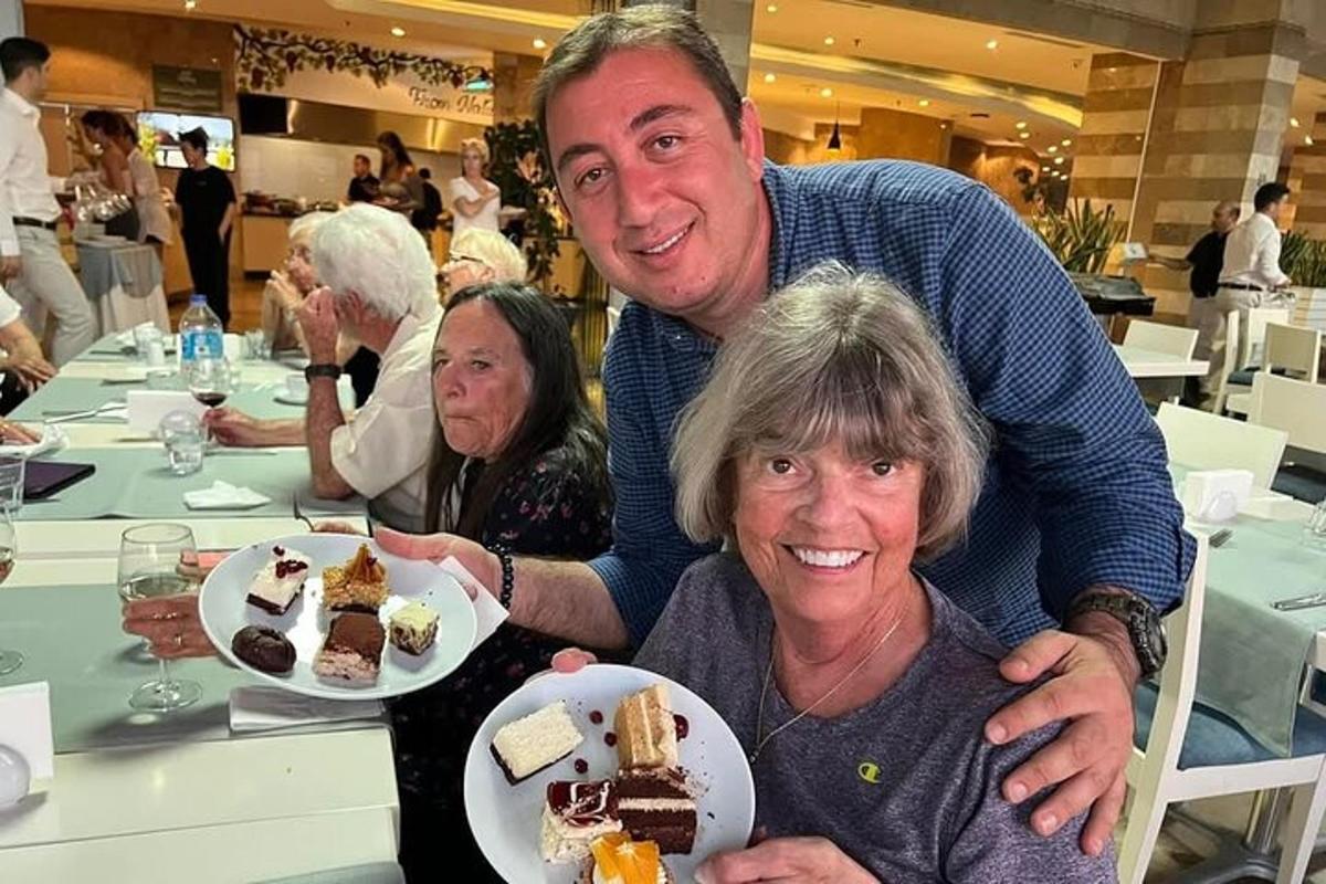 a man and a woman holding a plate of desserts
