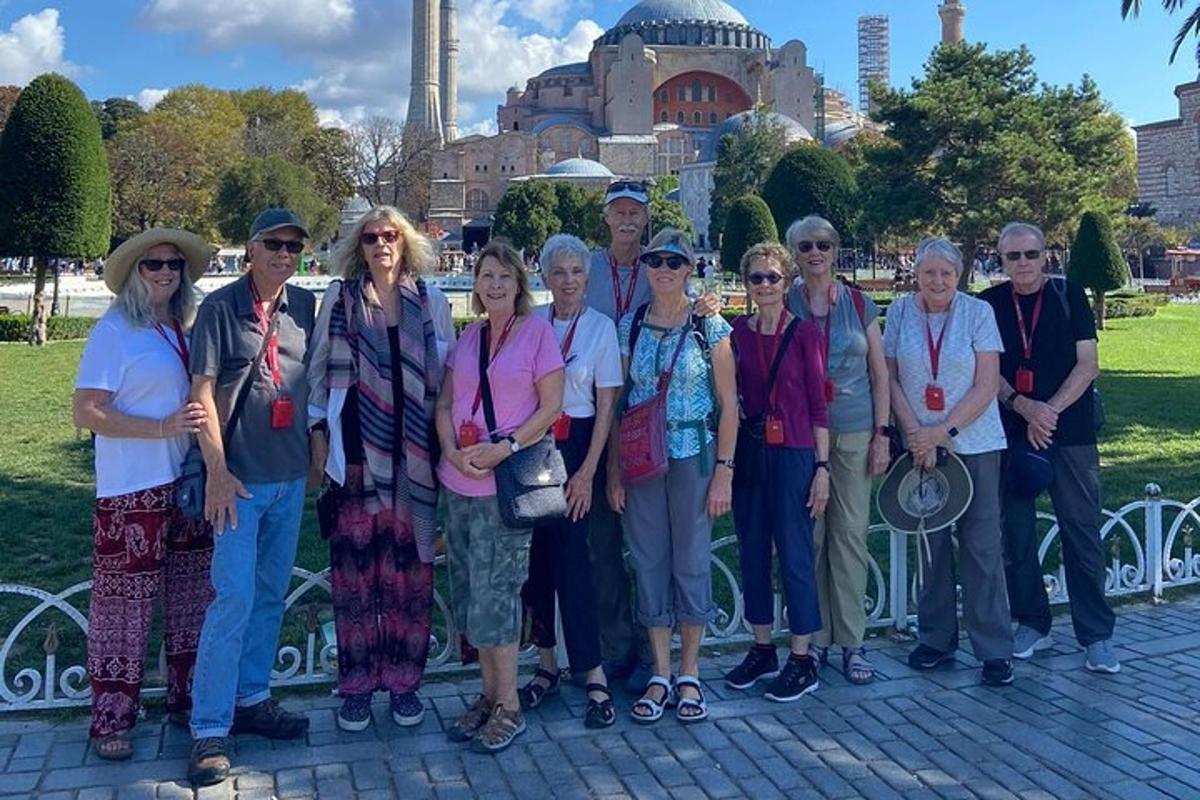a group of people posing for a picture in front of a building