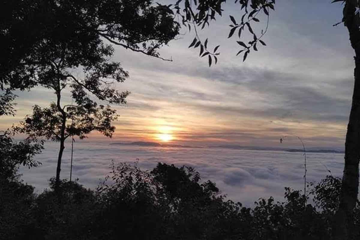 a view of the sun rising above the clouds