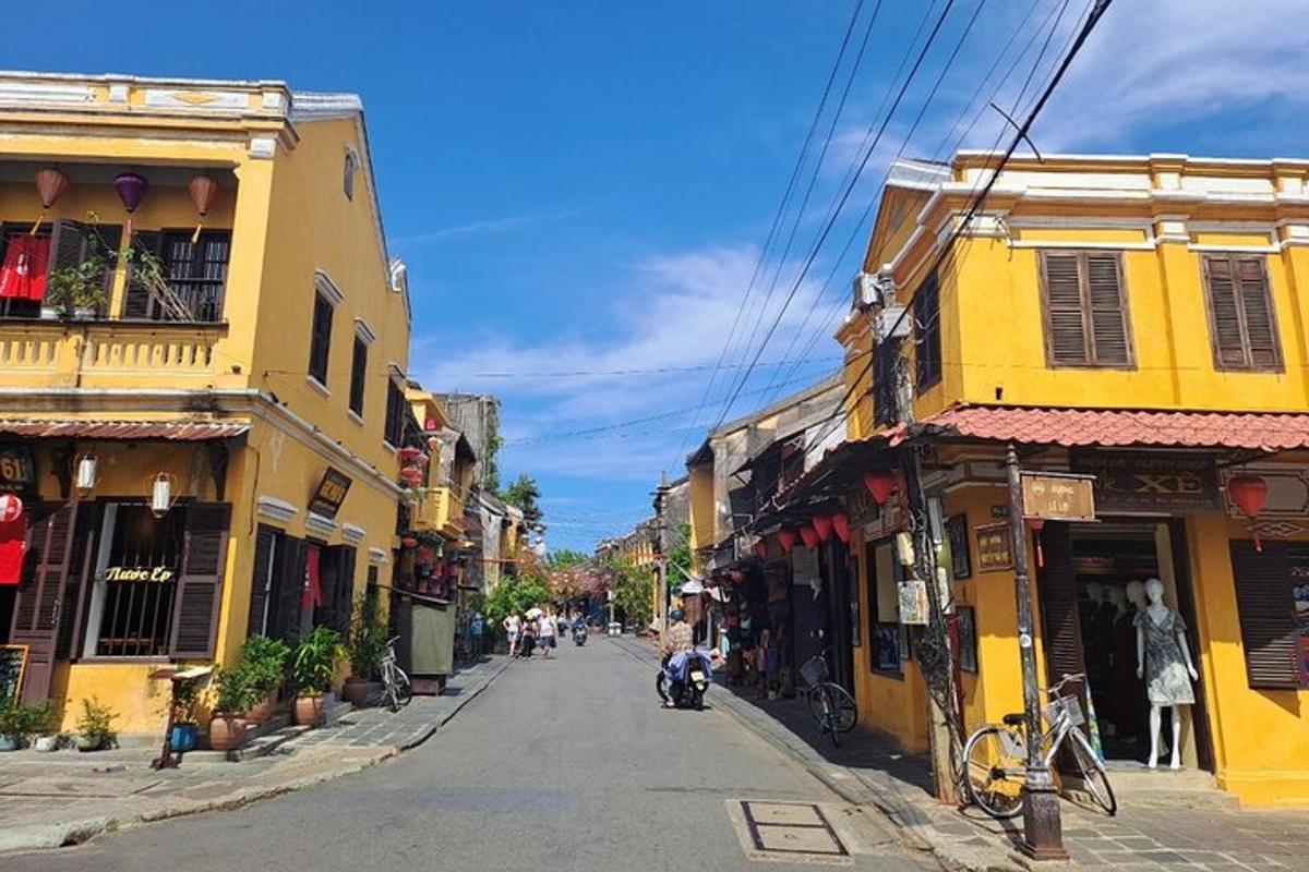 jalan kota dengan gedung-gedung dan seseorang mengendarai skuter