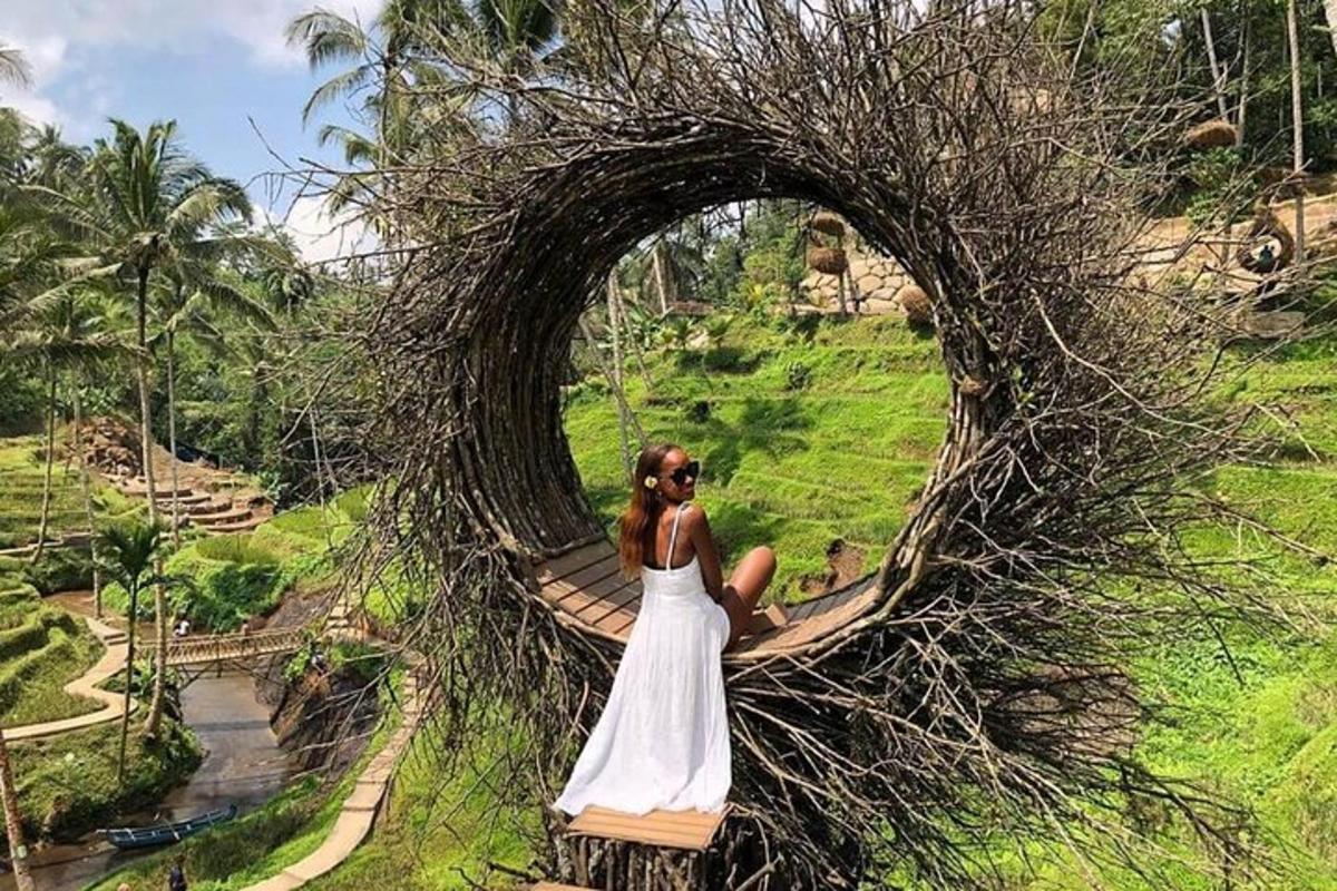 a woman in a white dress sitting on a tree root bridge