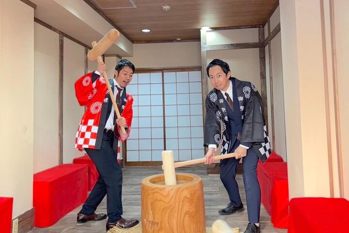 two men playing with a wooden mallet in a room