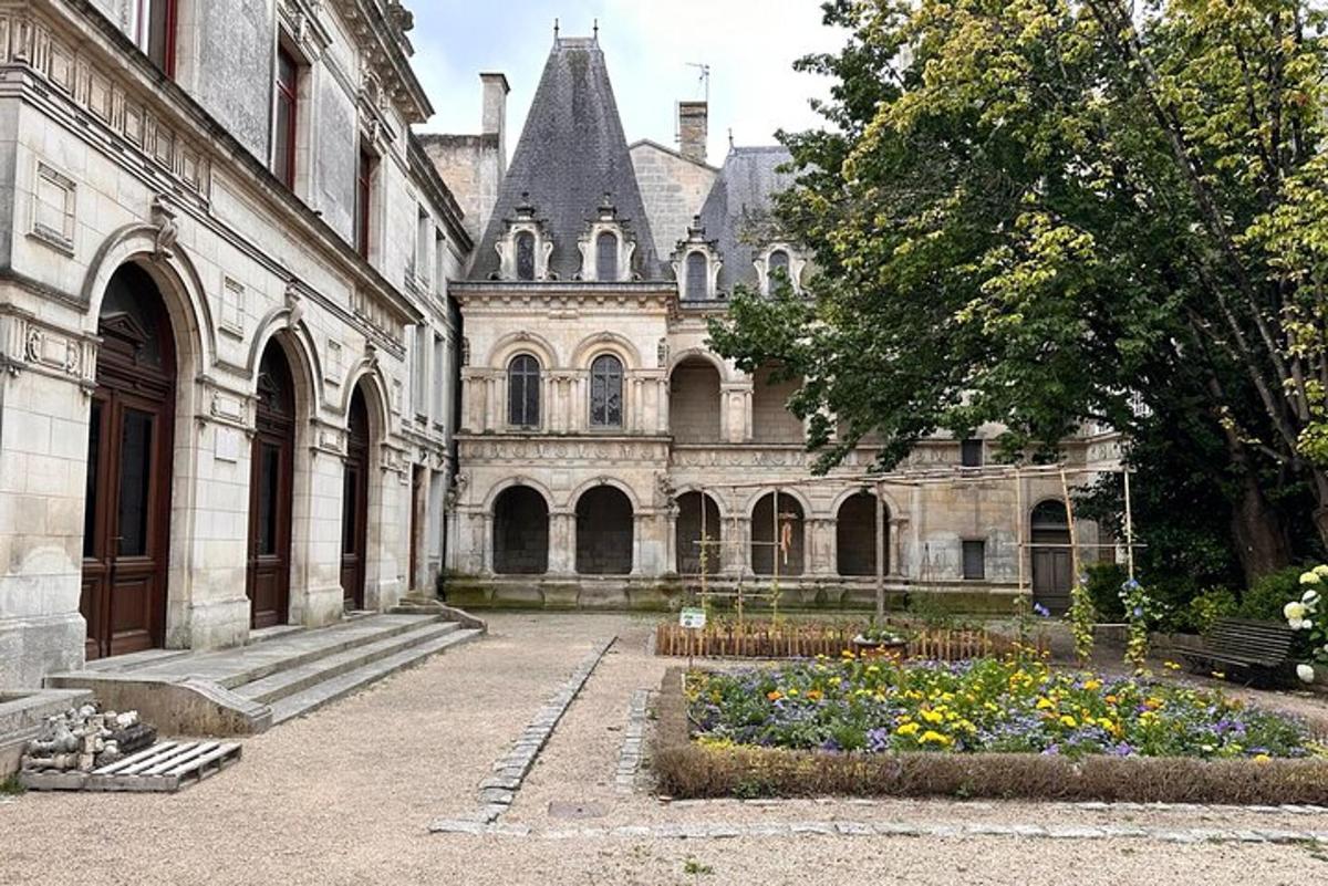 an old building with a garden in front of it