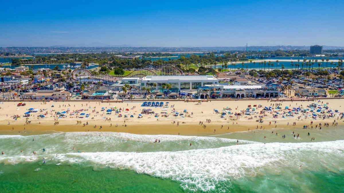 an aerial view of a beach with a crowd of people