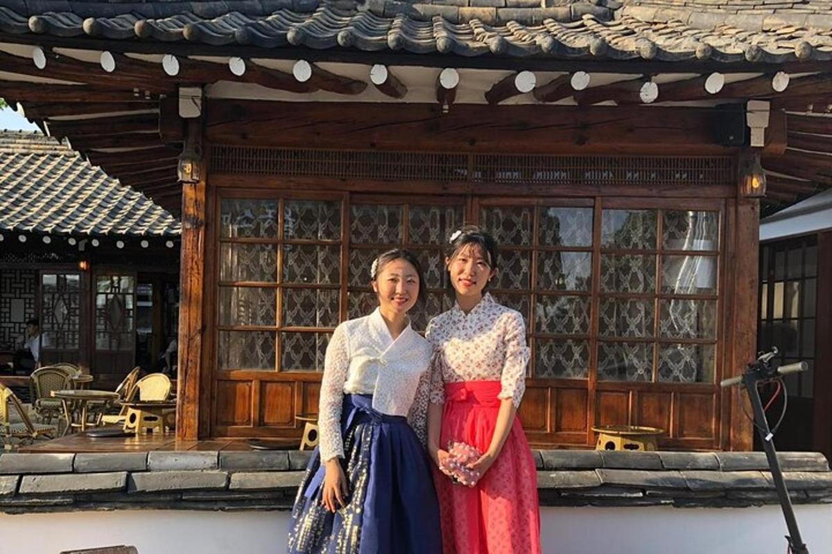 two women standing in front of a building