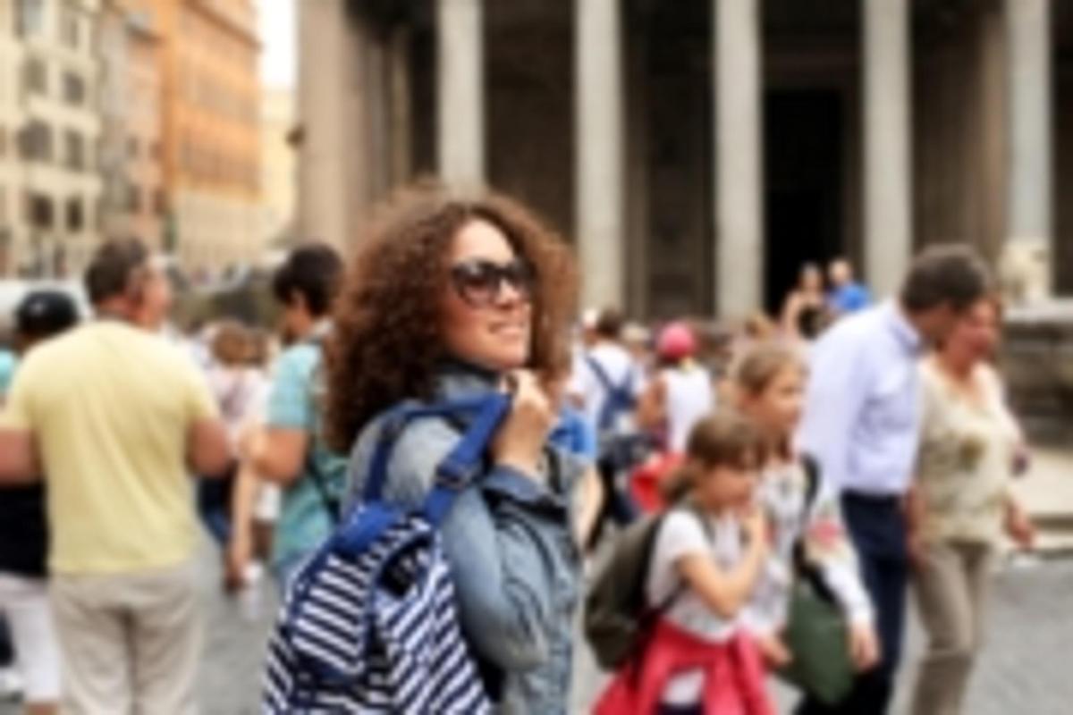 a woman is standing in a crowd of people