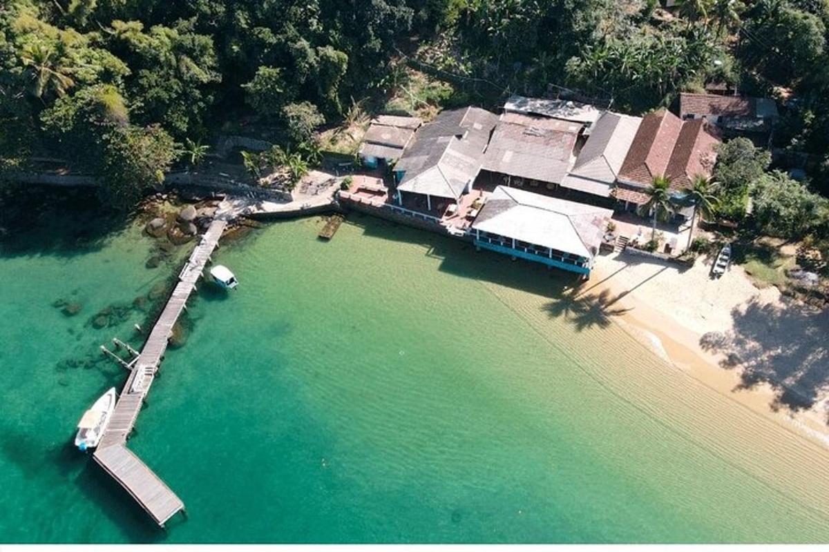 an aerial view of a house on the water