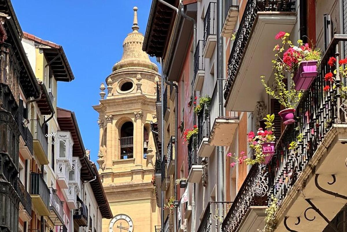 a clock tower in the middle of a street with buildings