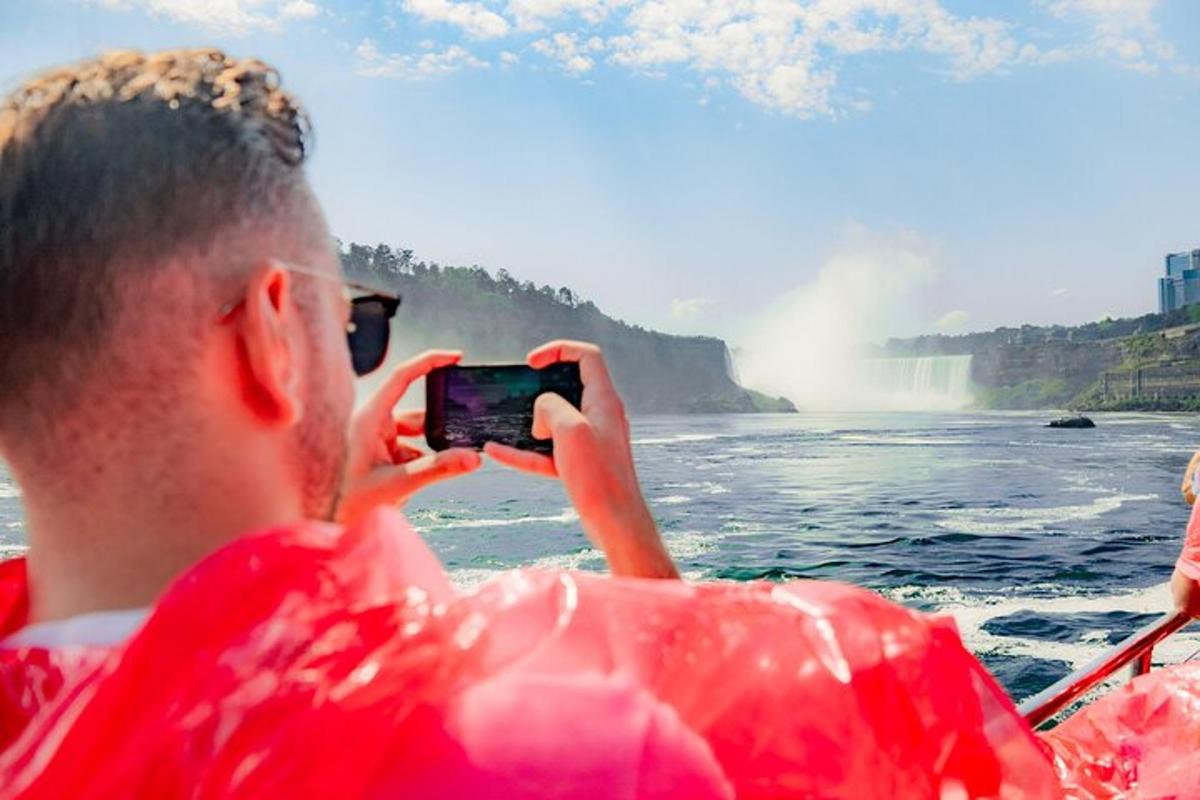 a man taking a picture of a waterfall from a boat
