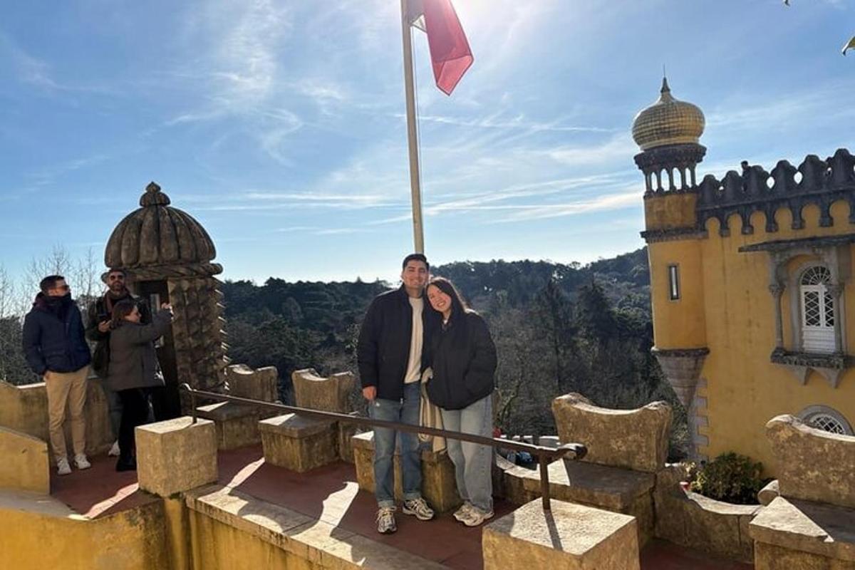 a man and a woman standing in front of a castle