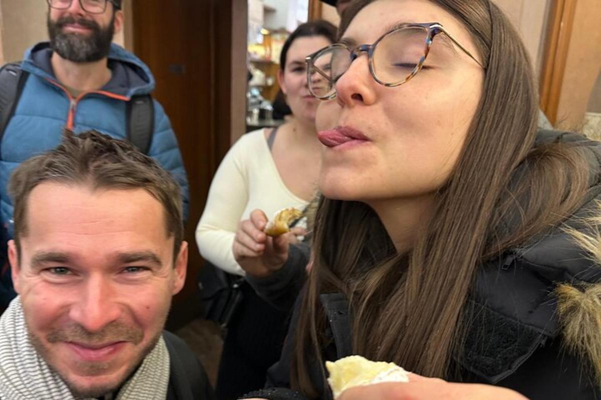 a man and a woman eating a piece of food