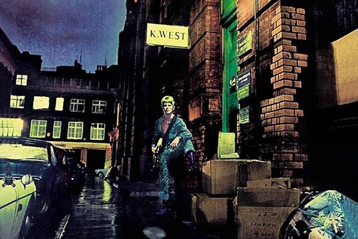 a painting of a person sitting on the side of a building
