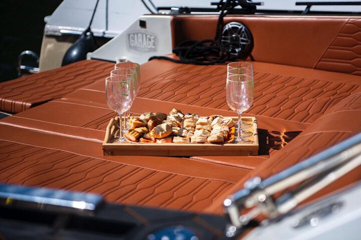 a table with two wine glasses and a tray of food