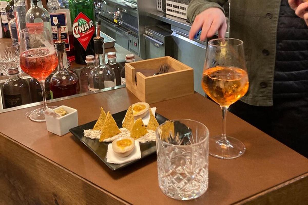 un tavolo con due bicchieri di vino e un piatto di cibo