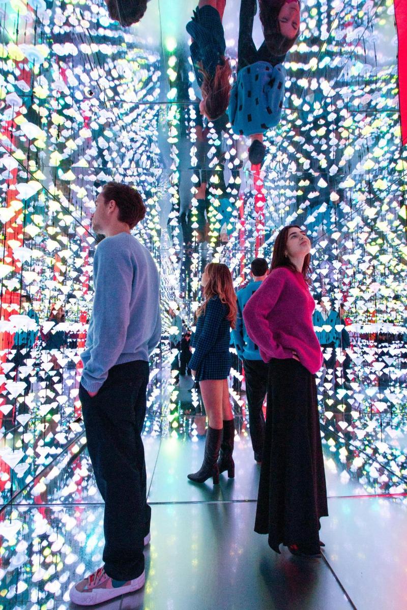a group of people standing in front of a christmas tree