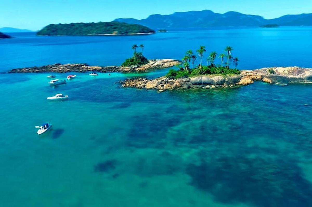 an island with palm trees and boats in the water