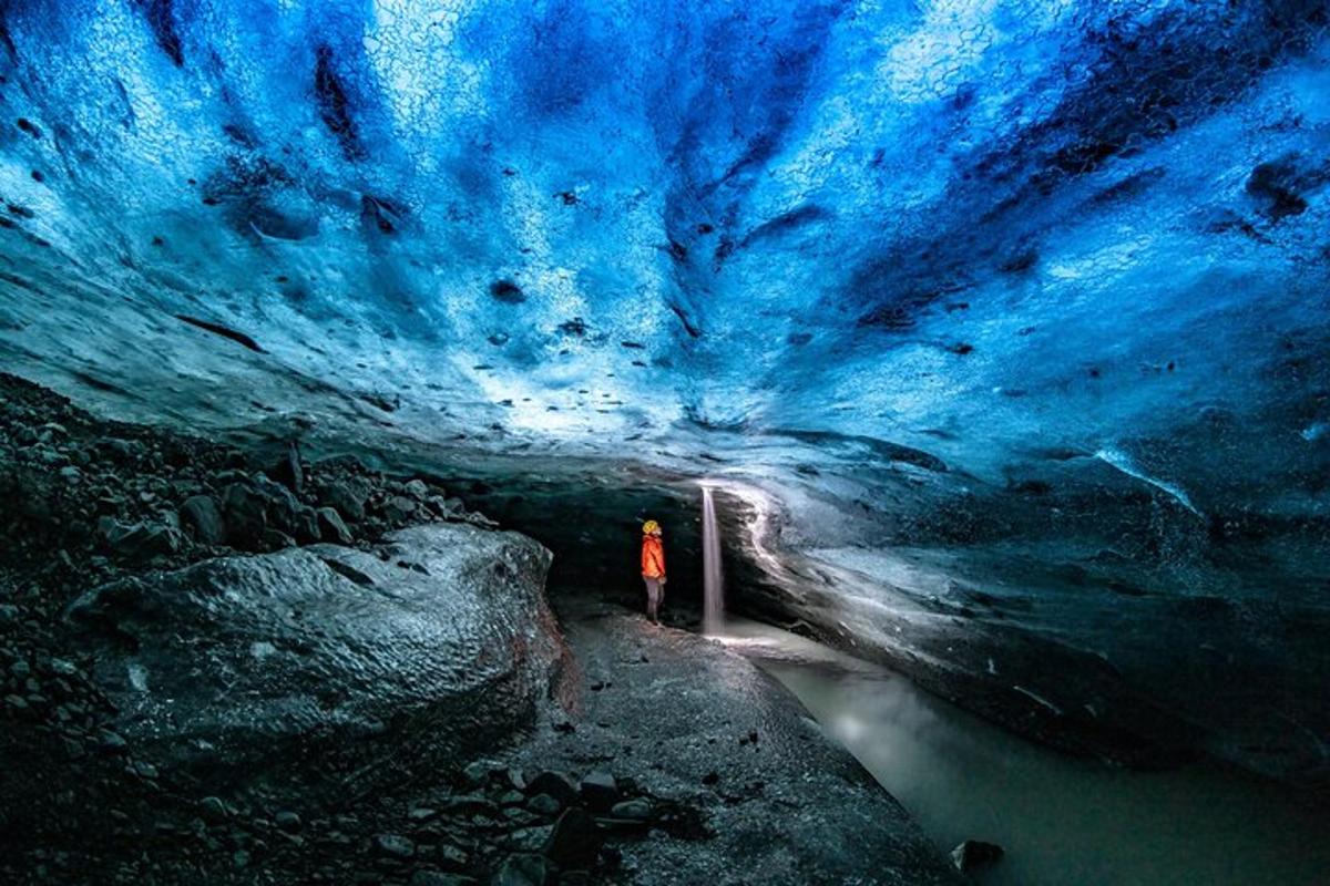 a person standing inside of an ice cave