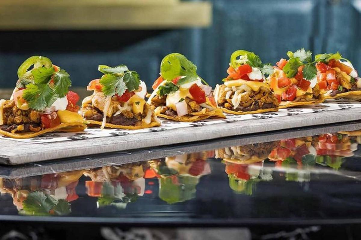 a row of tacos with birds on top of a table