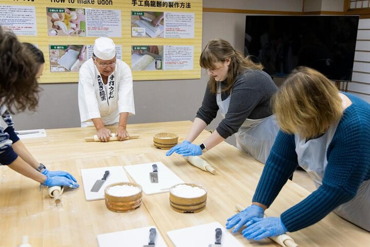 a group of people standing around a table with drums
