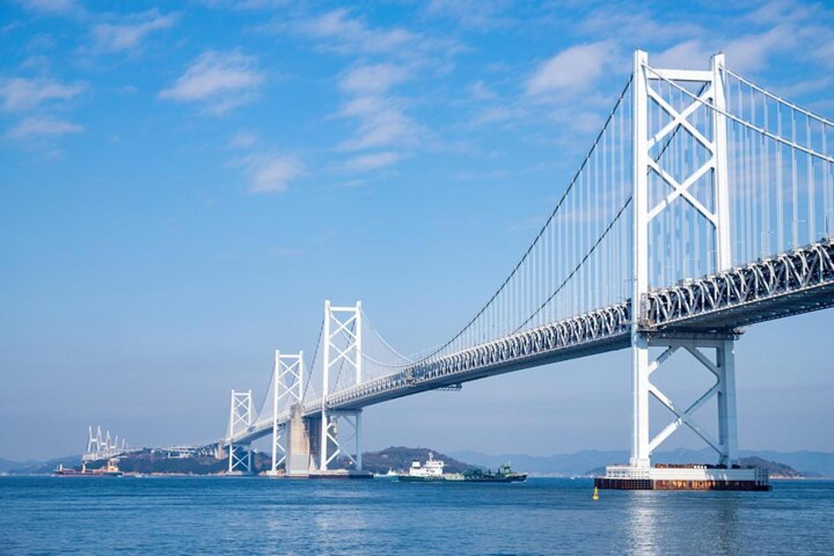 a bridge over the water with a boat under it