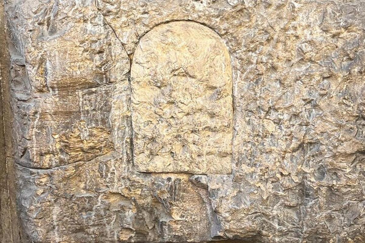 a stone wall with a window on it