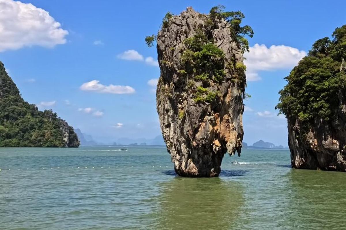 a group of rocks in the water near the ocean