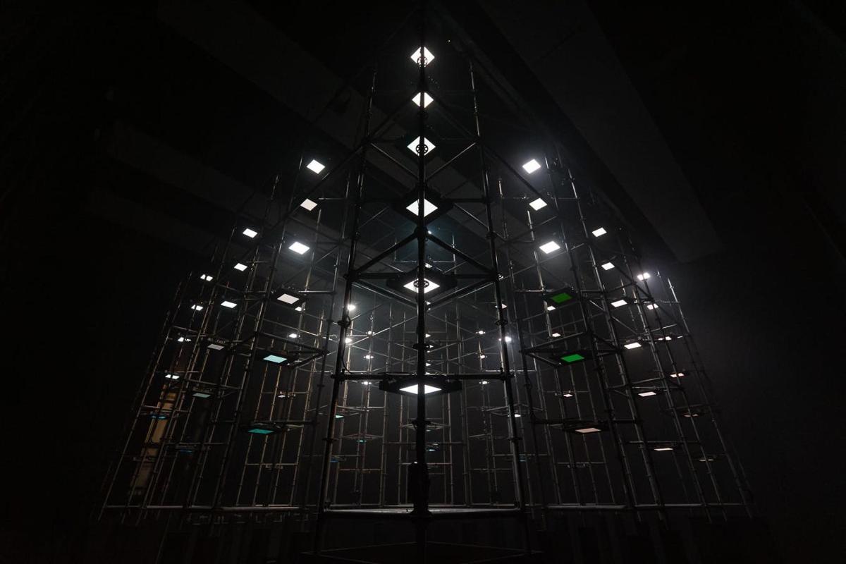a stained glass window with a cross in the dark