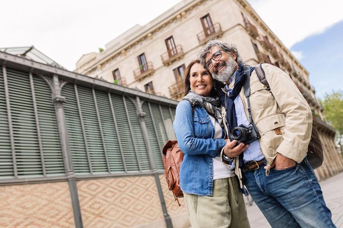 a woman standing next to a man holding a camera