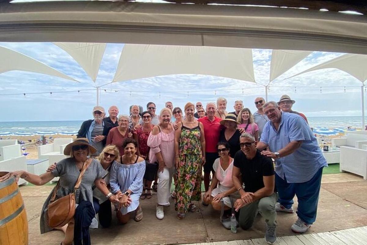 a group of people posing for a picture under an arch