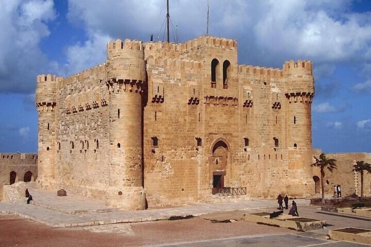 a large stone building with people standing in front of it