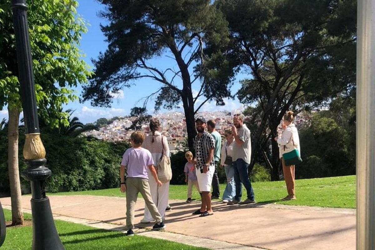 um grupo de pessoas em pé na calçada de um parque