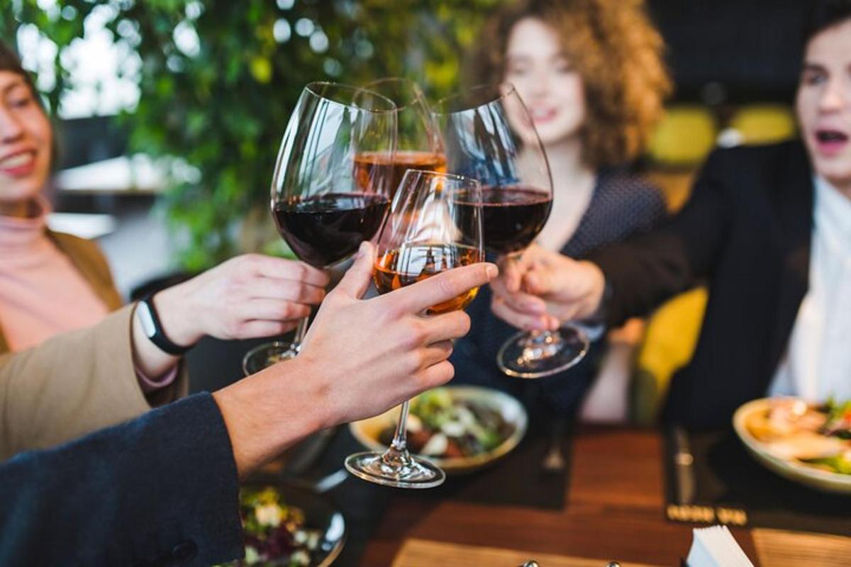 a group of people holding up glasses of wine