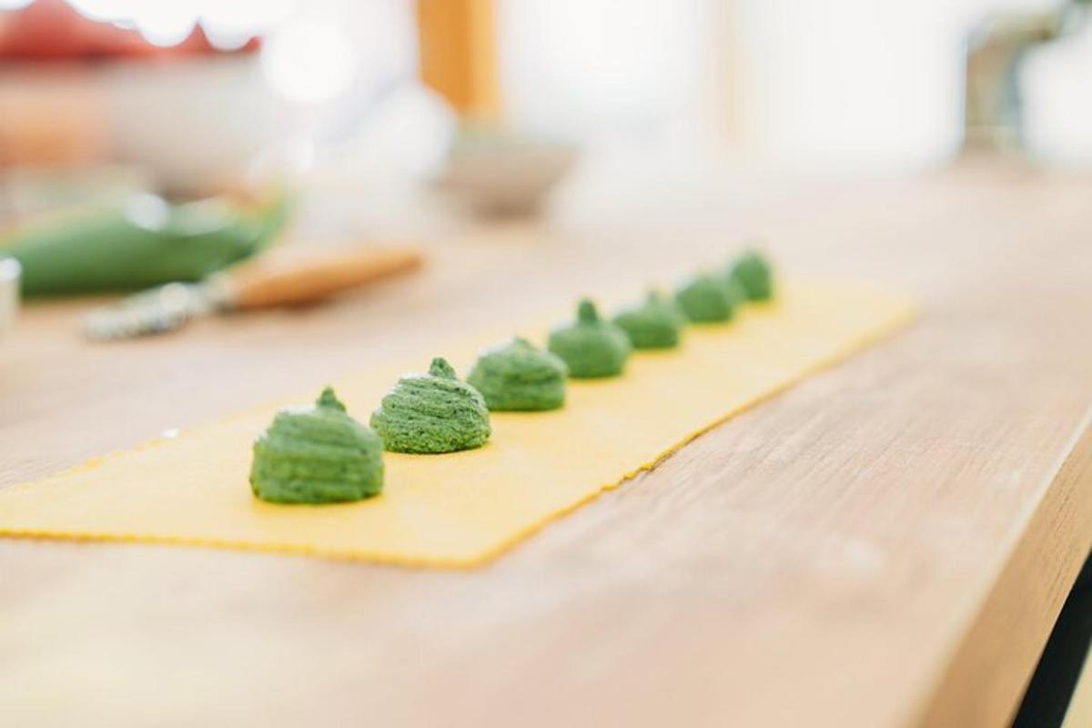 a line of green food on a yellow cutting board