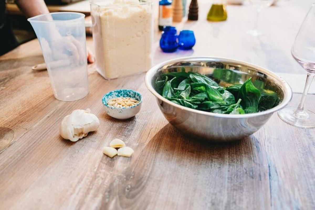 a wooden table with a bowl of food and a glass
