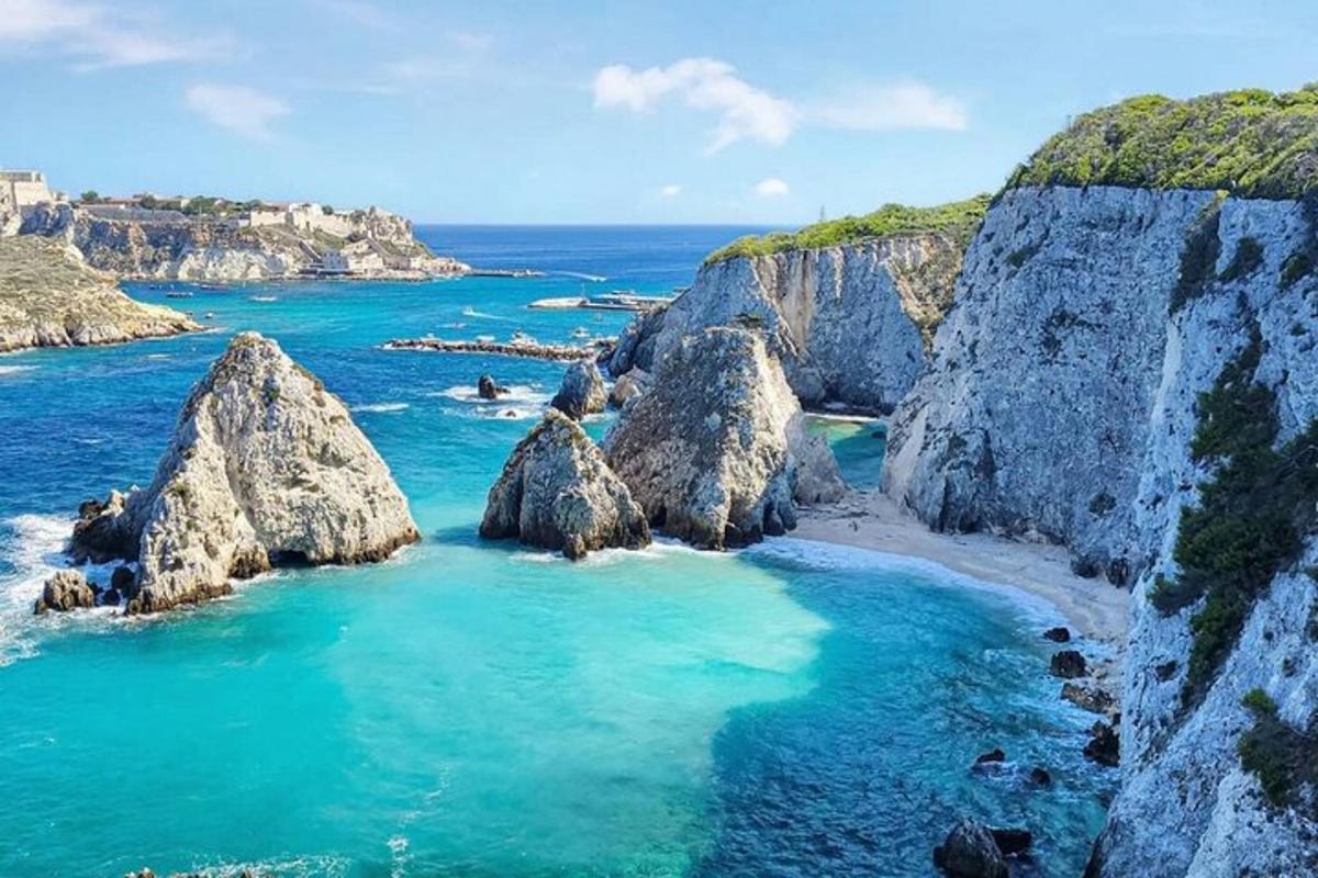 a view of a beach with rocks in the water