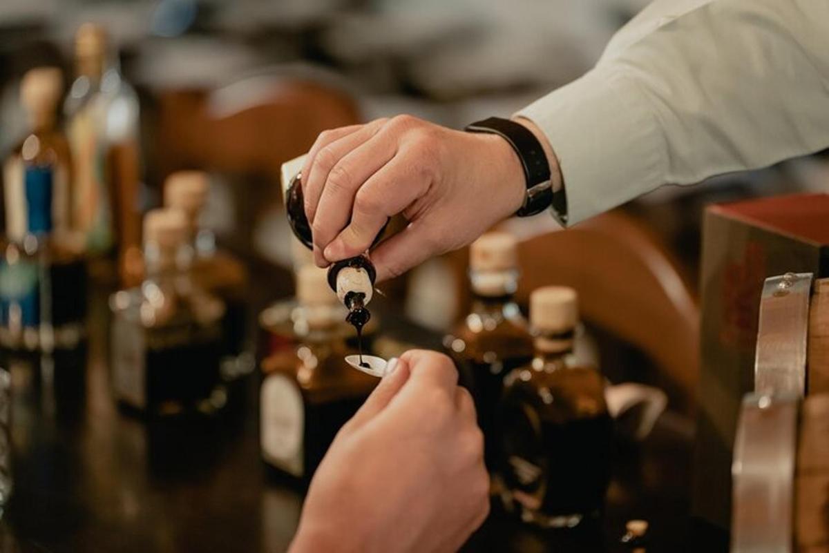 a person is holding a bottle of whiskey