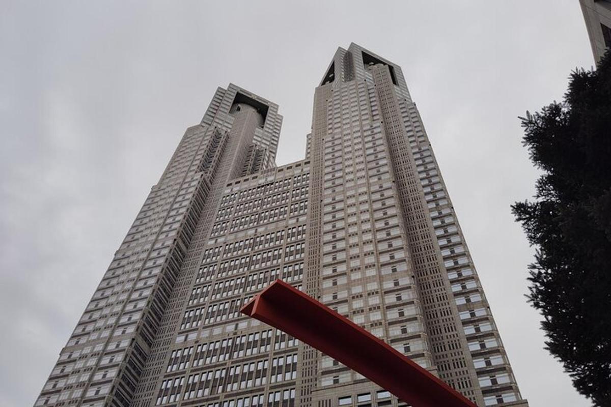 a tall building with a red sculpture in front of it