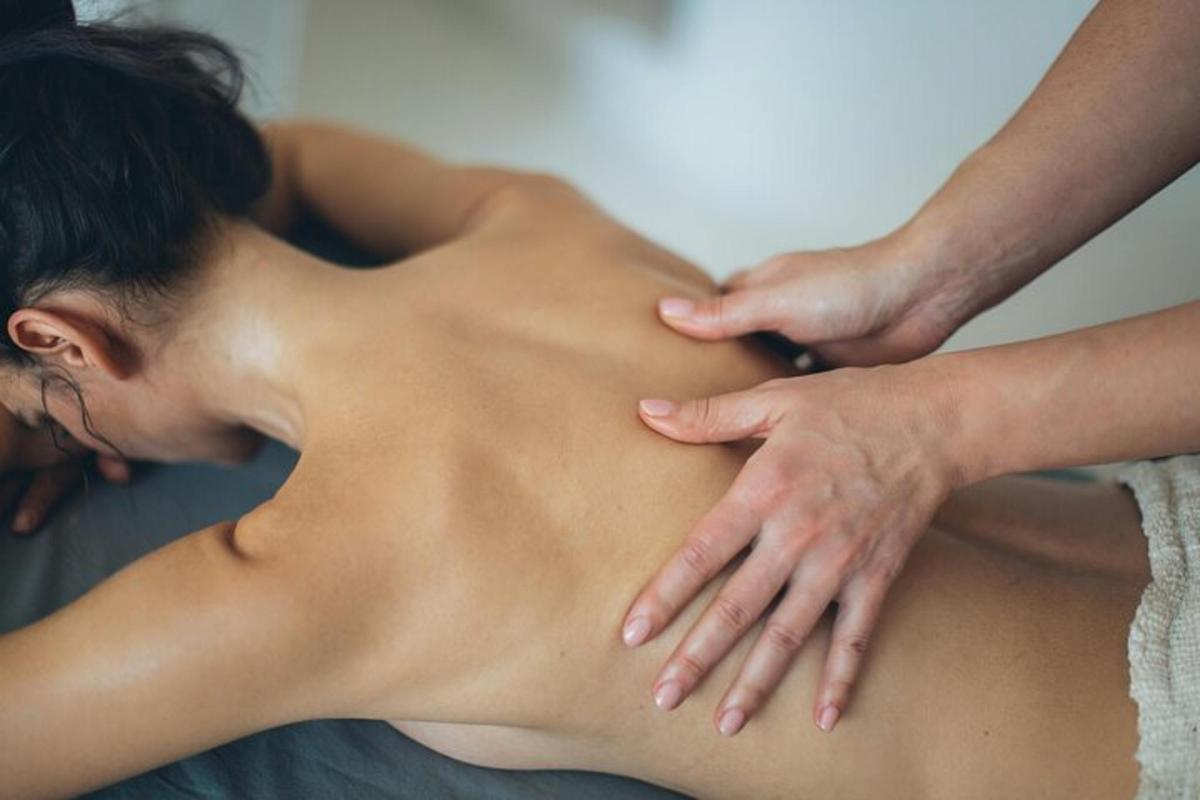 a woman getting a back massage from a therapist