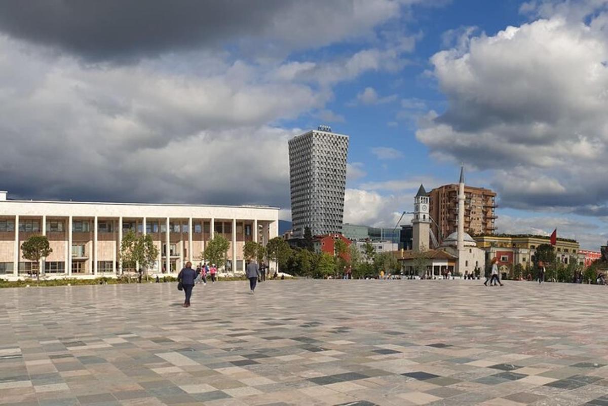 a group of people walking around a large plaza