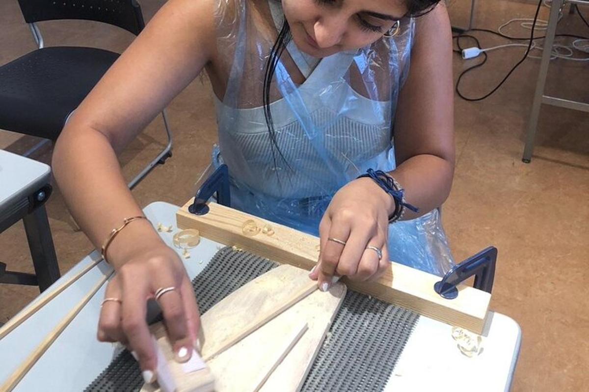 a woman is working on a piece of wood