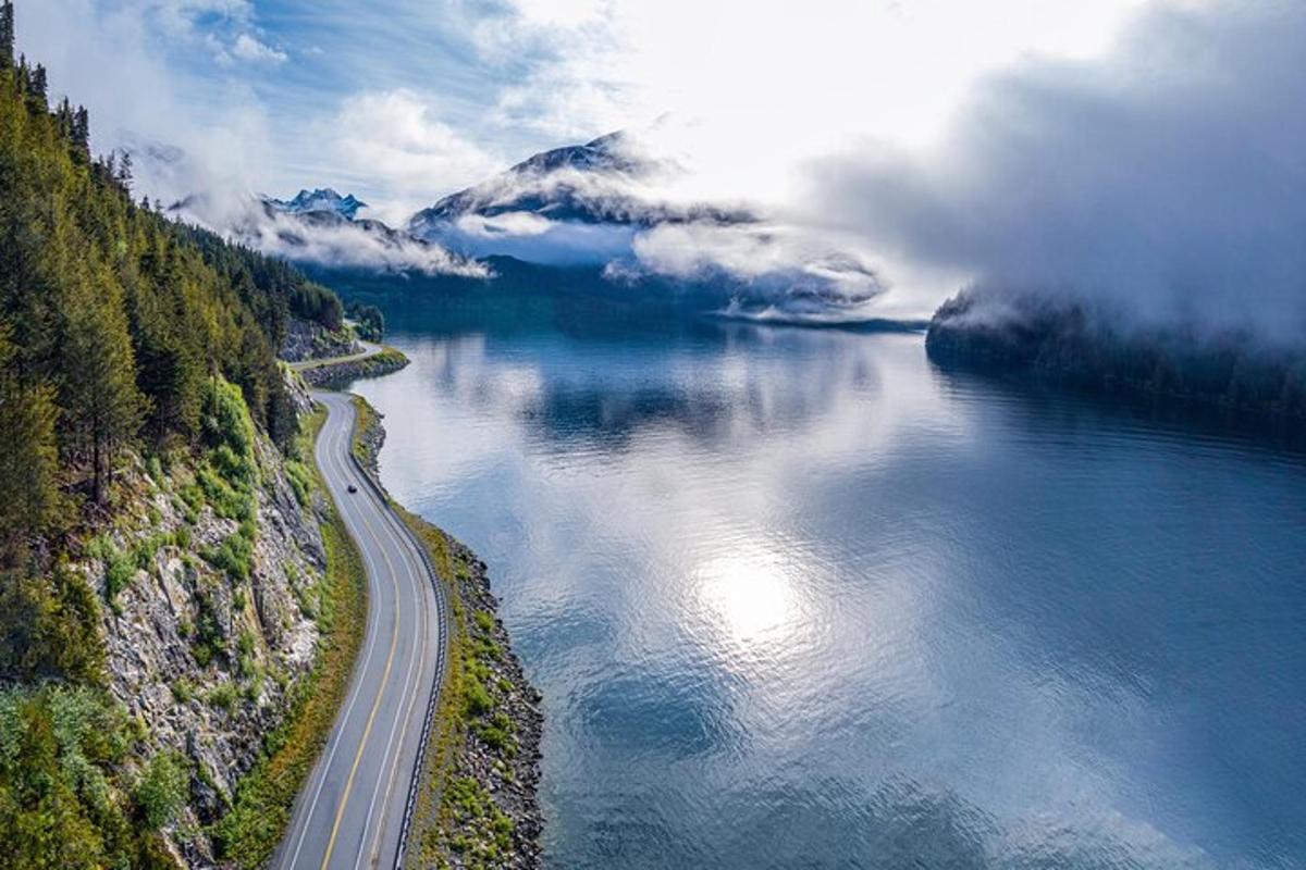 an aerial view of a river with a road next to it