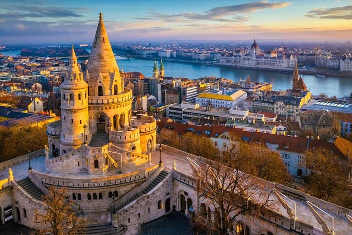 an aerial view of the parliament building in budapest at dusk