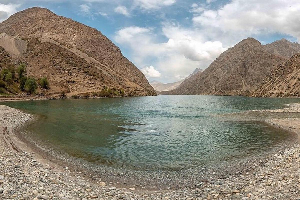 a body of water with mountains in the background