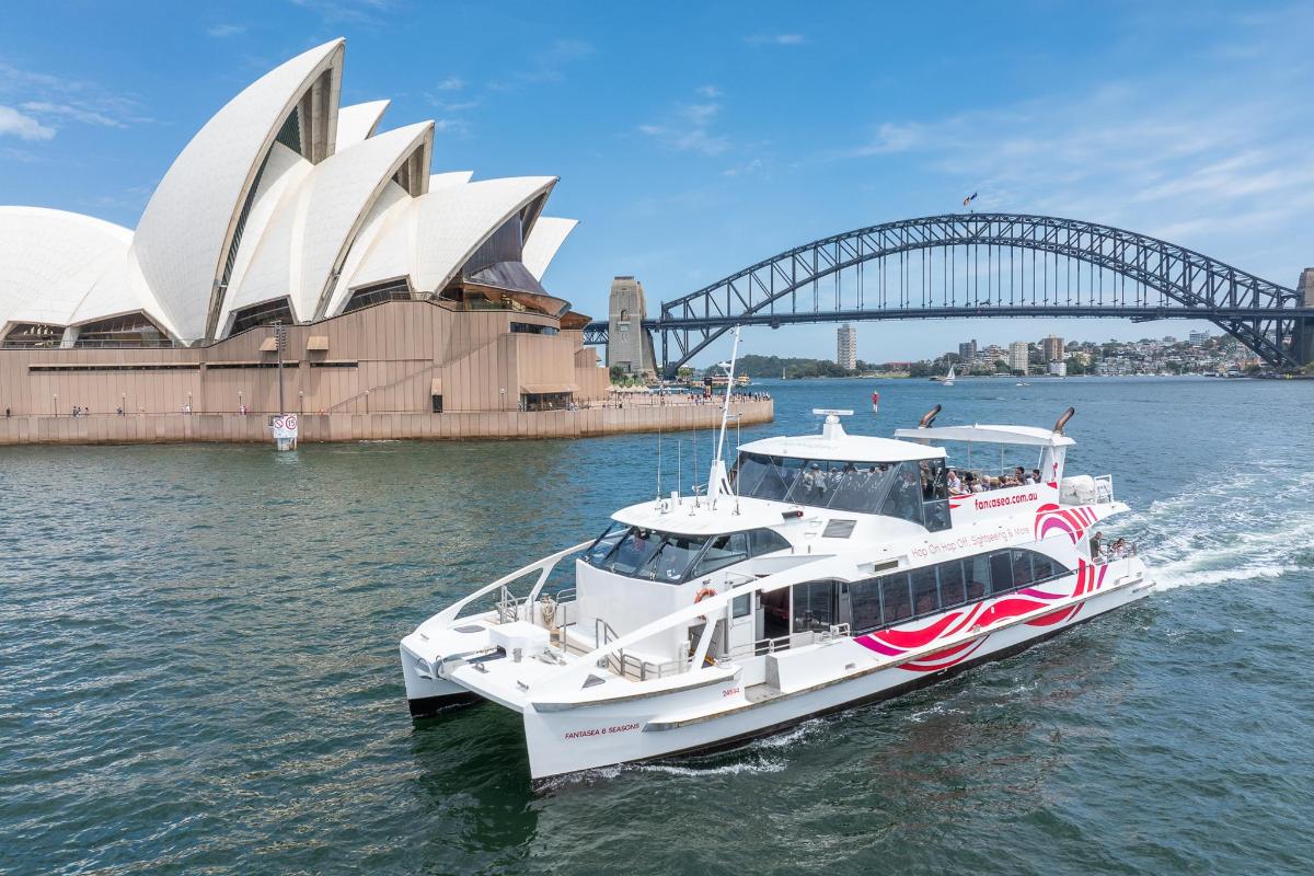 a boat in the water in front of the opera house