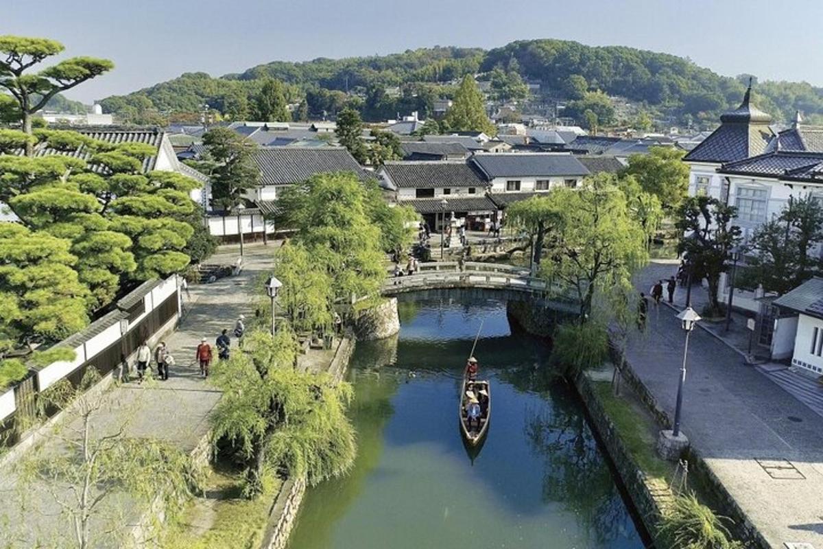 a boat in a river in a town with a bridge