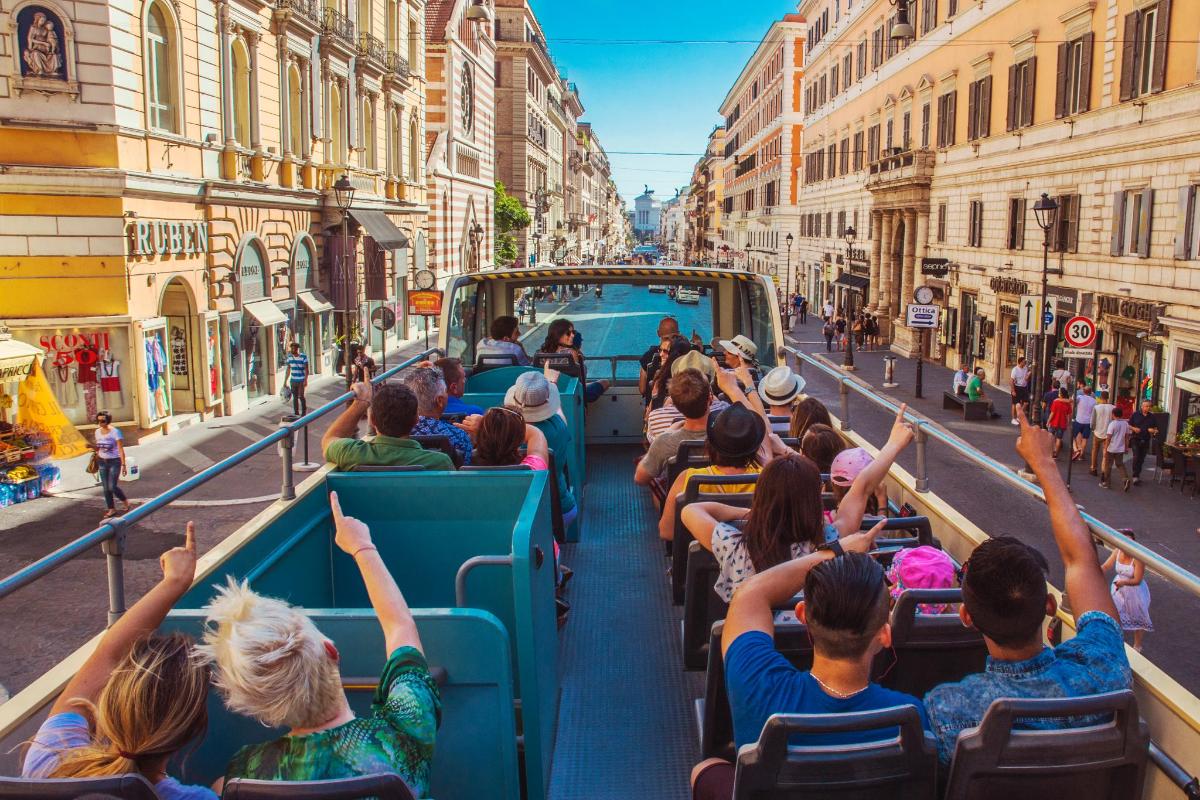 a group of people riding on a tram down a city street