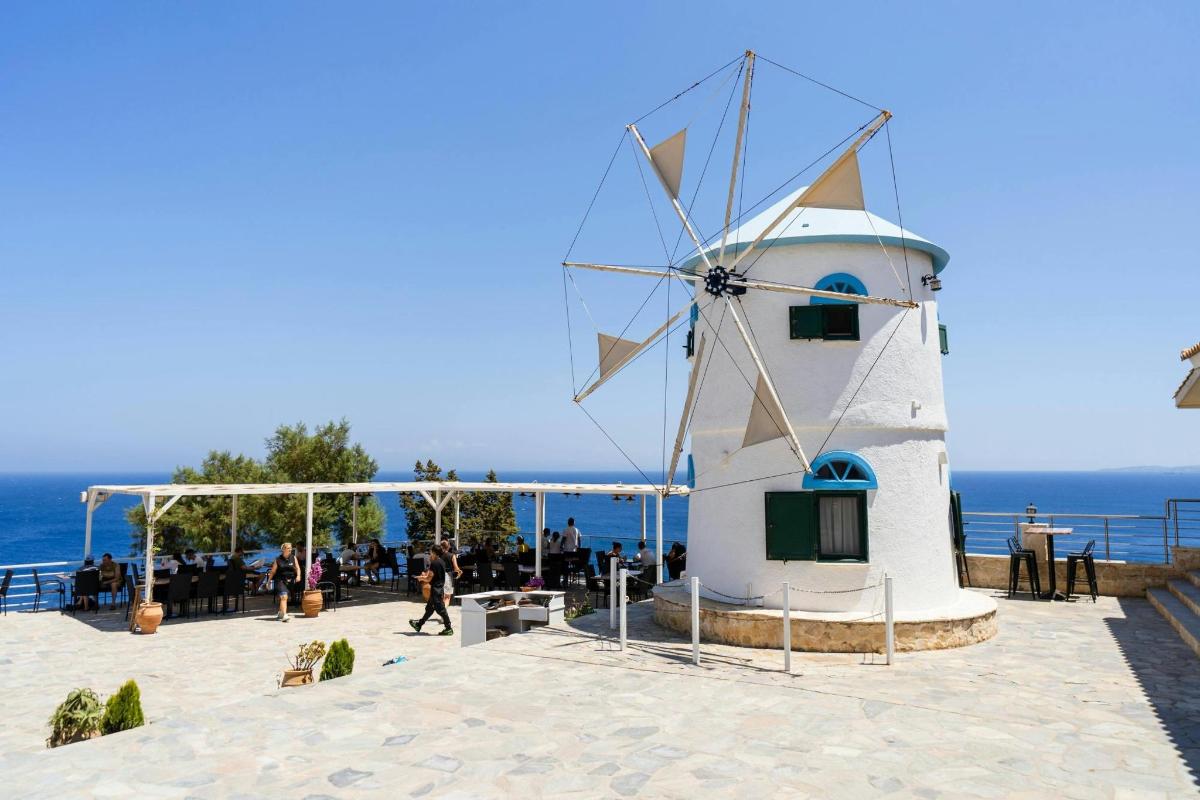 a windmill sitting on top of a beach