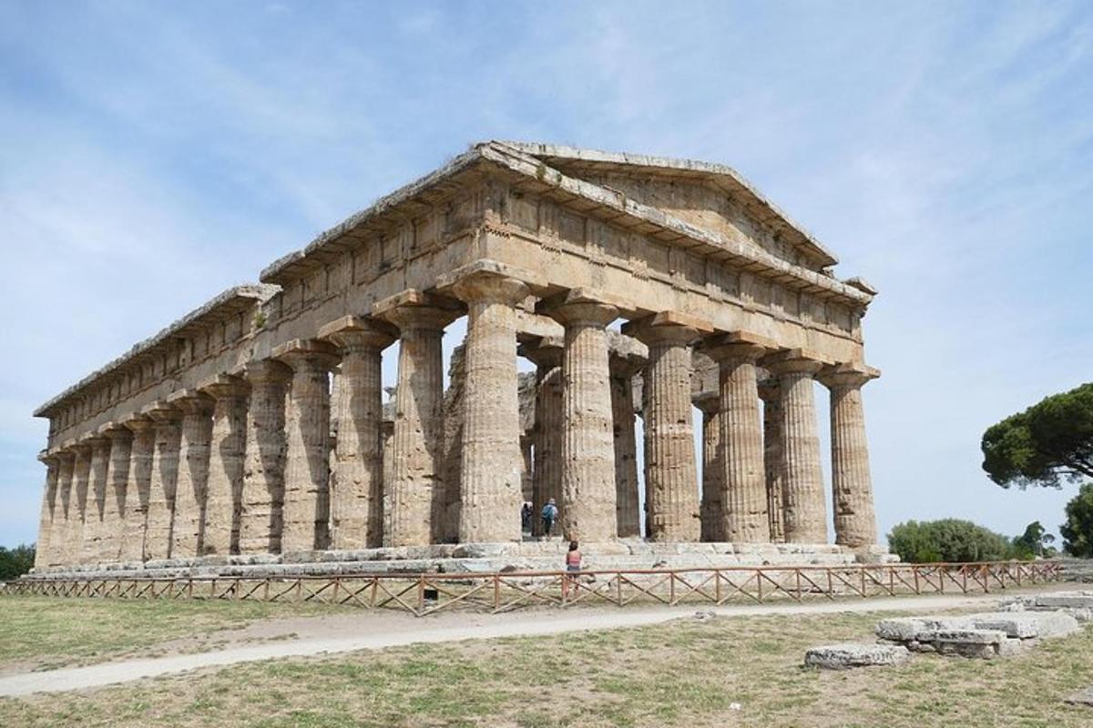 an ancient building with columns in a field