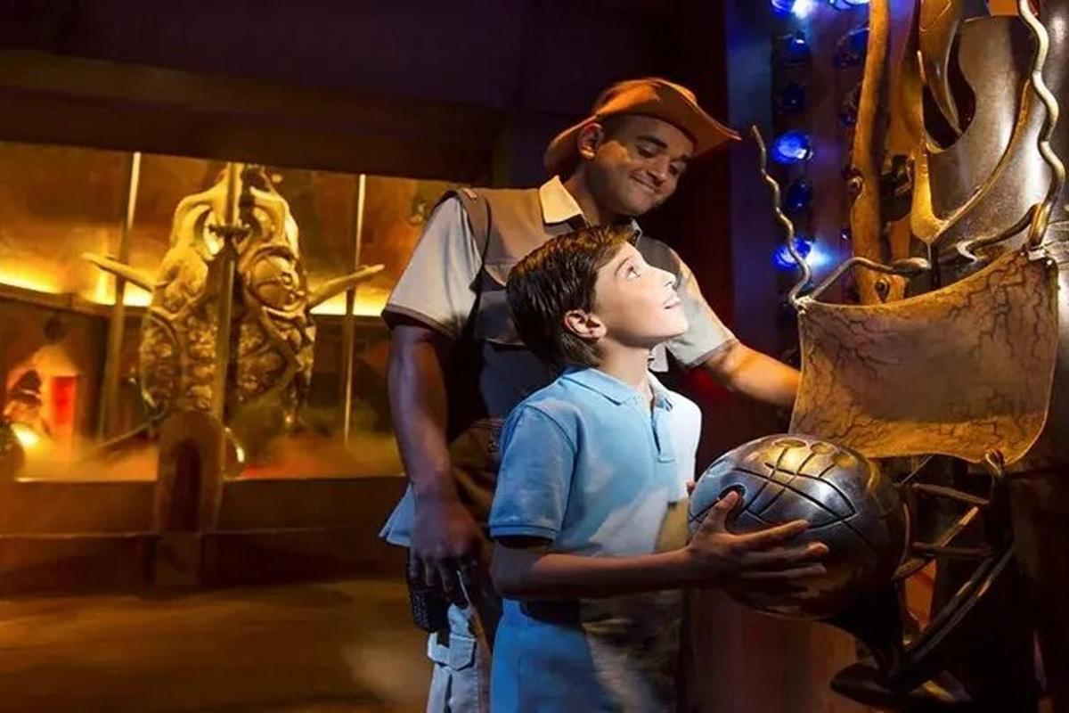a man standing next to a young boy holding a ball