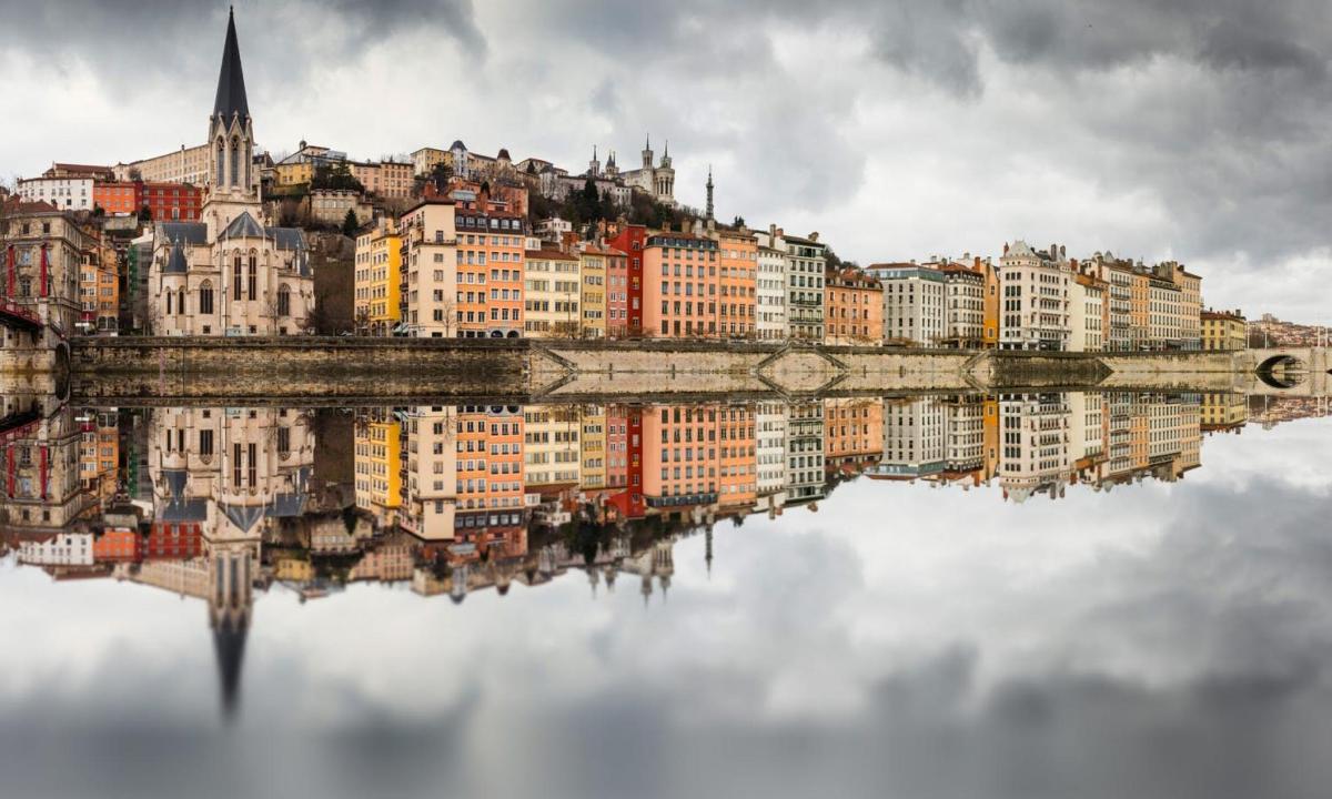 a reflection of a city in the water